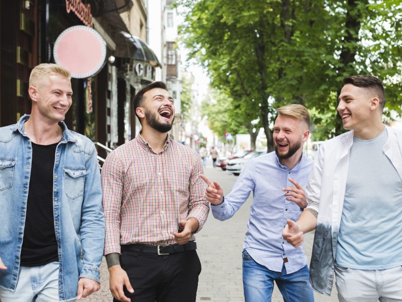 group-friends-walking-down-street-making-fun