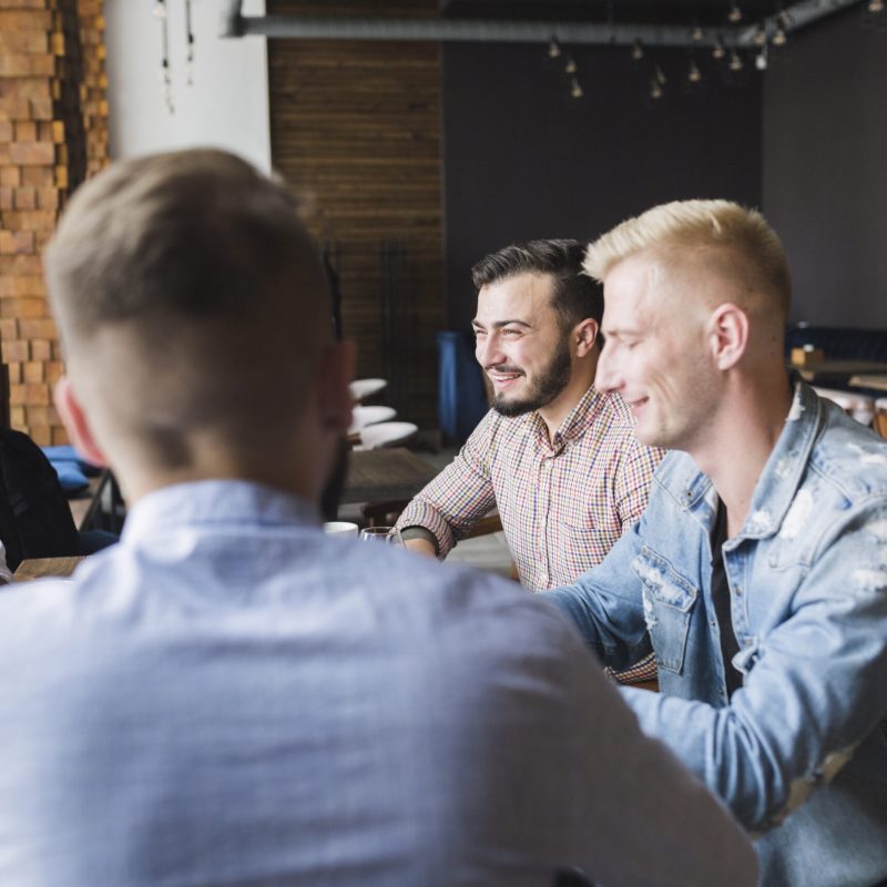 group-male-friends-sitting-restaurant